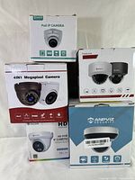 Front view of the 5 retail boxes of dome PoE IP cameras showing different brands and camera images with product features