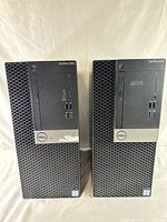 Two Dell OptiPlex 5060 and 5070 barebone desktop systems front view showing model numbers, power button, USB ports, and optical drive bay.