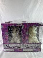 Front view showing the unicorn figurines inside sealed packaging