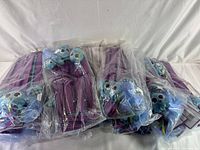 Photo showing multiple sealed Forever Pals blue turtle cat toys with purple wands in plastic bags
