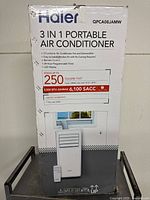 Front view of Haier 3-in-1 portable air conditioner box showing features and image of the unit with remote control.