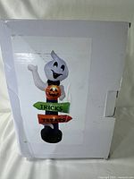 Photo of the product box with printed image of the inflatable ghost decoration on the front showing the product design and markings.
