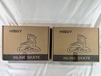 Two unopened cardboard boxes containing Hiboy inline skates shown side by side with the front printed with skate illustration and brand name.