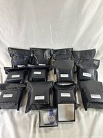 13 black padded envelopes containing the watches and 2 watches in boxes displayed