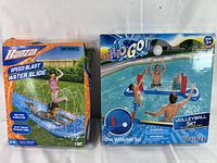 Photo showing boxed Banzer Speed Blast Water Slide and Bestway Inflatable Volleyball Set, both sealed and new.