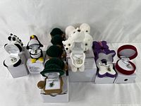 Front view showing multiple animal pendant necklaces including pandas, penguins, turtles, and polar bears displayed in their themed boxes.