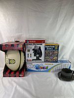 Lot arranged showing Mikasa rugby ball, Science Explorer microscope kit, Science Fiction Stories DVD six pack, Fun Science telescope box, and black plastic items.