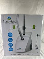 Front of box showing product image, model SF-547, key features like 80 minutes continuous steam, 1500 watts power, quick heat-up, and 4 included accessories.