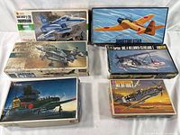 Six vintage airplane model kits in original boxes with box art showing detailed aircraft illustrations.