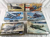 Six vintage airplane model kit boxes arranged in two rows showing front box artwork and condition.