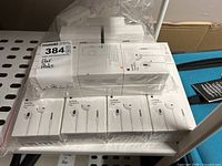 Lot of 10 Apple EarPods with 3.5mm headphone plug, stacked and shrink-wrapped for sale.