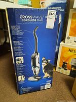 Front of boxed upright vacuum and wash unit with product image and dog graphic