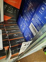 Multiple sealed Ledger Nano X boxes showing quantity and packaging