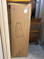 Boxed futon packaging upright in storage unit