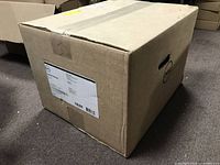 Sealed Dell shipping box with handle cutouts and shipping label