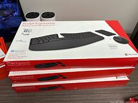 Three stacked Microsoft Sculpt Ergonomic Desktop boxes