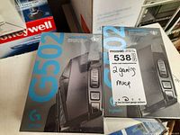 Two sealed Logitech G502 Lightspeed boxes side by side showing front packaging and lot sticker