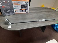 Full view of the club laid on table with packaging behind