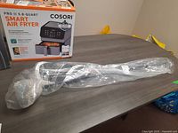 Full length of the driver in protective plastic on table