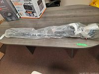 Driver fully wrapped in plastic on table