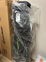 Full view of TaylorMade golf bag wrapped in plastic, showing overall lot