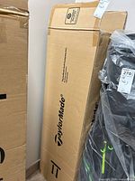 Tall sealed cardboard box printed with TaylorMade logo