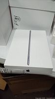Closed original white box for iPad on shelf