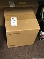 Two sealed Sonos Sonance In-Ceiling speaker boxes stacked on floor