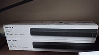 Two sealed Sony HT-X8500 sound bar boxes stacked side view
