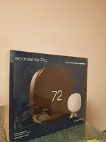 Front of ecobee Smart Thermostat Premium box showing thermostat display set to 72°F and accompanying SmartSensor.