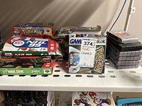 Assorted boxed games and loose cartridges on shelf