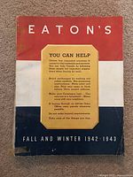 Cover photo of vintage Eaton's catalog Fall and Winter 1942-1943 with tri-color red, white and blue with text and condition wear marks.