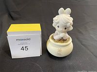 Front view of Precious Moments figurine kneeling on base