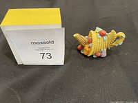 Photo of a 1999 Precious Moments cornucopia figurine with corn and pumpkins