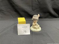 Front view of Precious Moments porcelain figurine depicting a praying child in Native American attire.