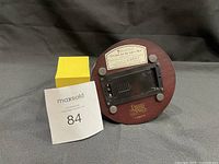 Bottom view showing music box mechanism with label 'O Come Let Us Adore Him 2000' and Precious Moments logo on wooden base.