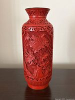 Front view showing detailed floral carvings and vase shape