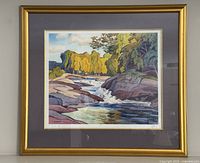 Full view of the framed print on wall showing frame, mat, and glass