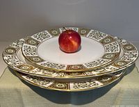 Stack of three platters with apple for scale