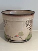 Front view of the vintage Denby Savoy stoneware pot showing landscape design with trees and houses.