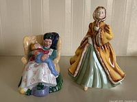 Front and side view of both Royal Doulton figurines together on a flat surface with neutral background.