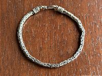 Top view of closed bracelet on wood background