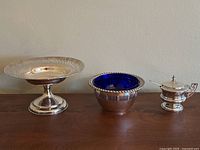 Overview of three items: pedestal dish, serving bowl with cobalt liner, mustard pot with lid and spoon
