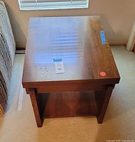 Top view of square wood end table showing wood grain and flat surface.