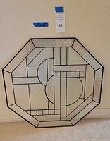 Full view of the octagonal leaded glass panel with geometric design.