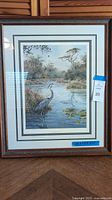 Full front image of framed print showing the Great Blue Heron in a marsh setting with detailed matting and wooden frame.