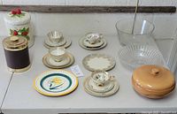Lot overview showing 4 vintage Bavarian cup and saucer sets arranged with various plates and bowls, including ceramic cookie jar and serving bowls