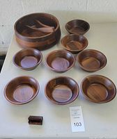 Full set arranged on table showing large serving bowl, eight small salad bowls, and small trinket box