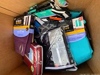 Box with various new curtains and curtain accessories inside, visible packaging from Eclipse brand.