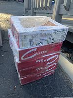 Stacked six boxes of Ototto brand ceramic floor tiles, each box showing 12x12 inch tile dimensions and packaging labels